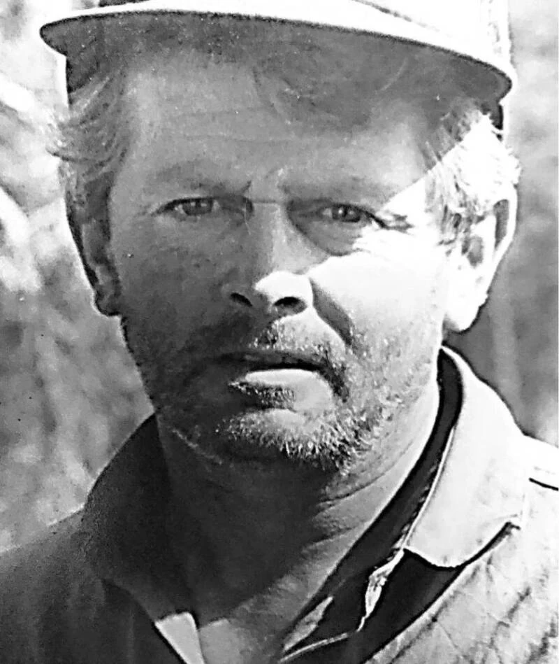 Black-and-white photograph of Gary Francis Poste wearing a brimmed cap.